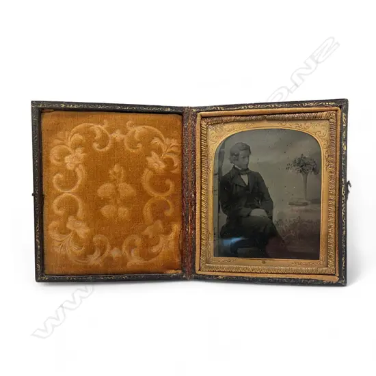 Leather cased ambrotype - man and vase of flowers,